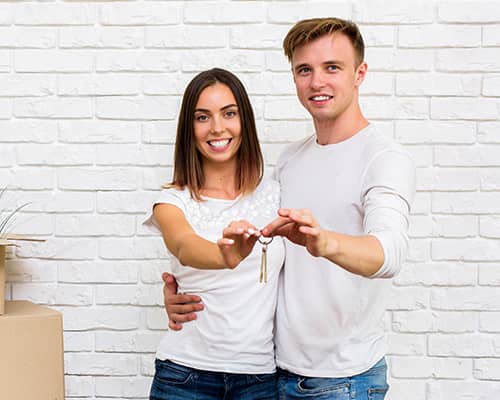Happy couple holding their new house keys